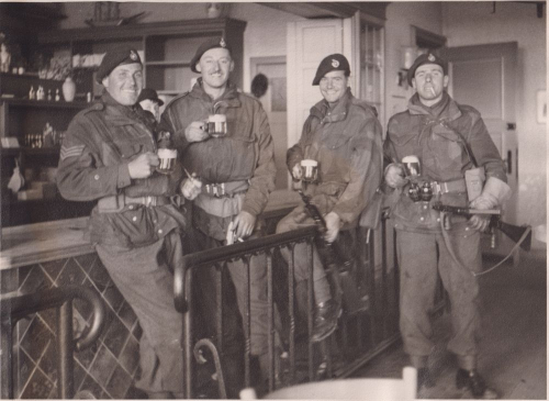 Four Royal Marines relaxing with drinks. 