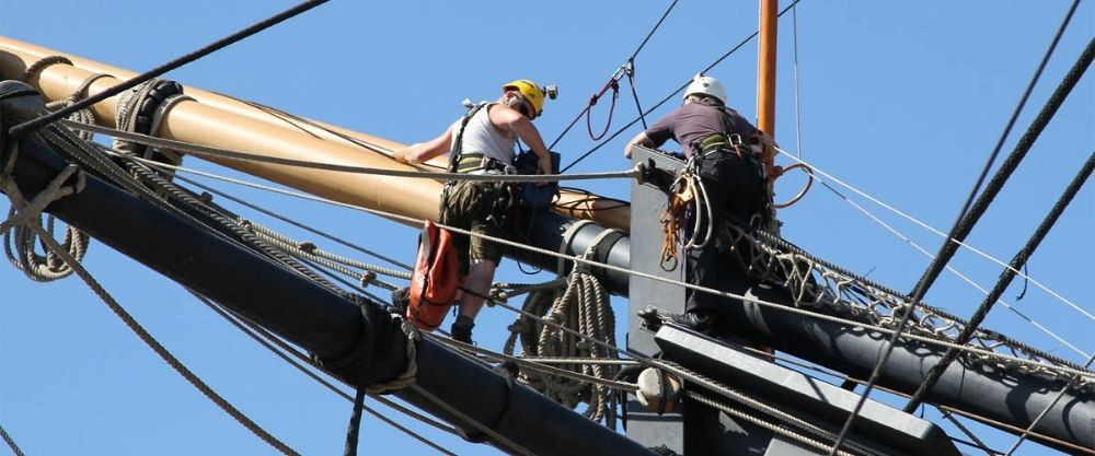 Two riggers on the bow of HMS Victory. 