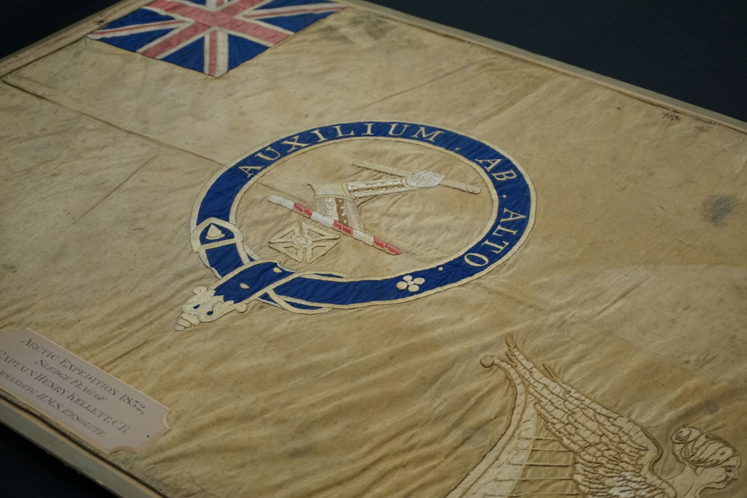 Close up of the Kellett sledge flag with the Latin motto visible. 