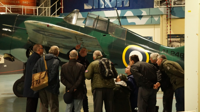 A group of visitors look at a Second World War plane at the Fleet Air Arm Museum.