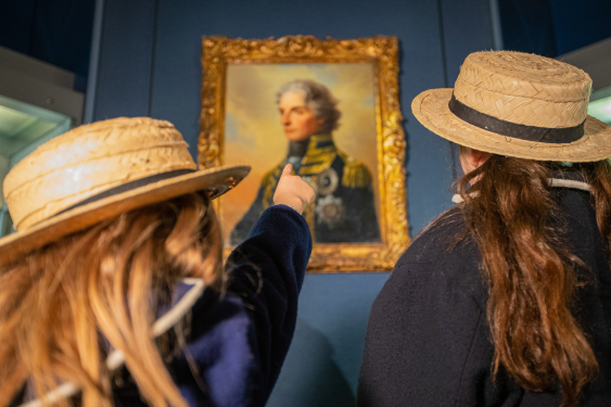 Two school girls learn about Vice Admiral Lord Nelson in the gallery dedicated to him. 