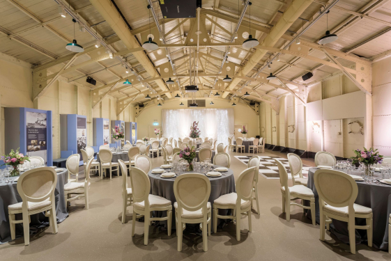 Tables and chairs set up for a celebration onboard HMS Caroline.