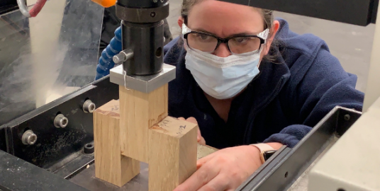 An engineer testing building materials in a lab. 