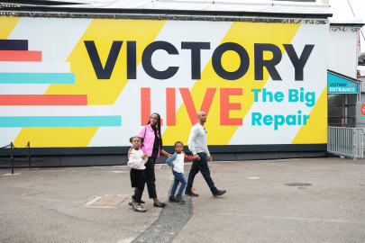 A family walk past Victory Live on their way to learn about her restoration. 