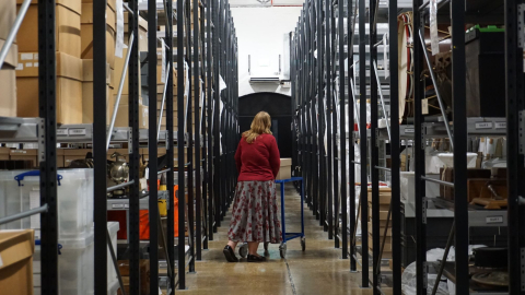 A librarian walking through the National Museum of the Royal Navy's storeroom. 