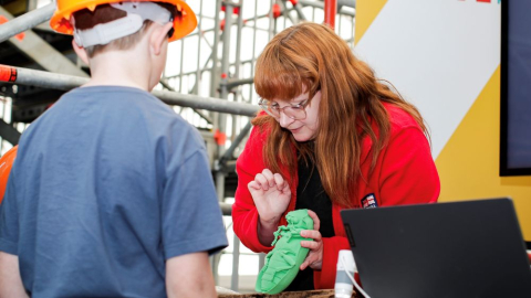 A child learning about the pests living on HMS Victory from a conservator.. 