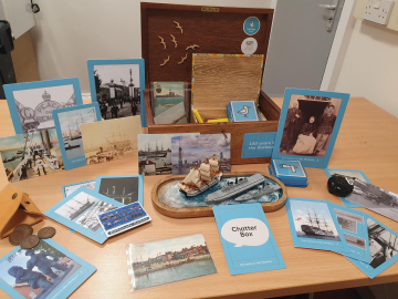 A box full of nautical items open on a table. 