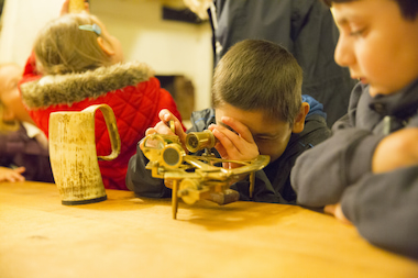 School children using original 18th century navigation equipment.