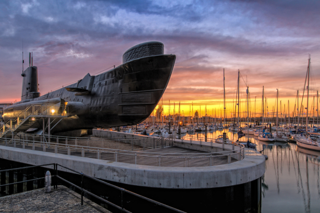 HMS Alliance sits in dock at Gosport harbour at sunset.
