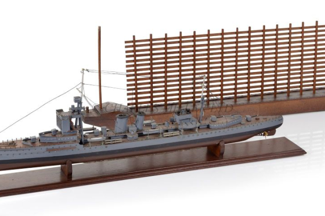 Scale model of HMS Dragon against a white background. 