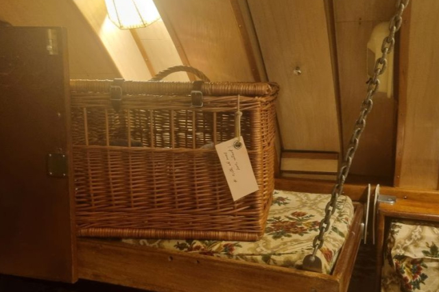 A wicker cat carrier for HMS Alliance's pet cat. 