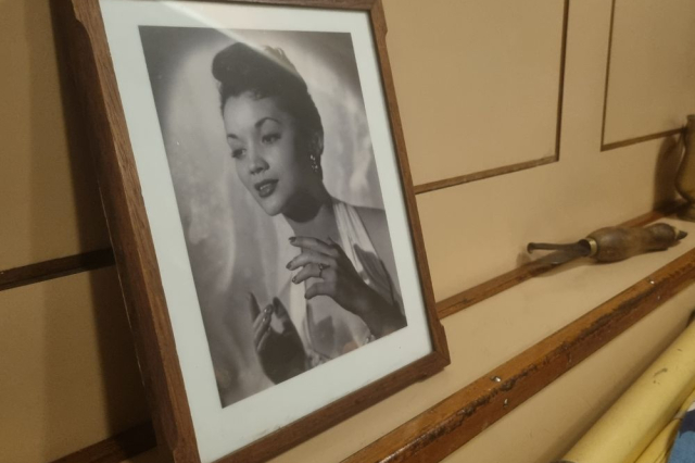 Framed photograph of Lita Roza onboard HMS Alliance. 