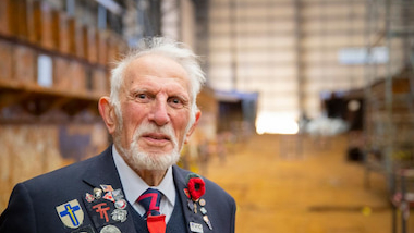 An elderly male veteran wearing his medals. 