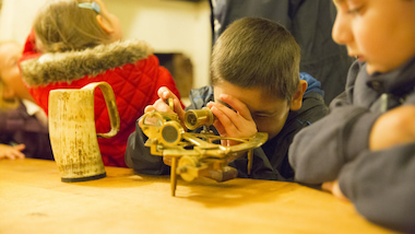 School children using original 18th century navigation equipment.