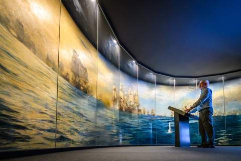 A visitor looking at the Trafalgar Panorama by Wyllie.  
