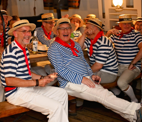 Group of people on table singing