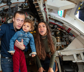 A family having fun onboard HMS Alliance. 