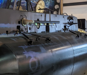The untold stories logo next to the X24 submarine