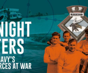 A group of Night Hunters in front of the ship badge for HMS Hornet. 