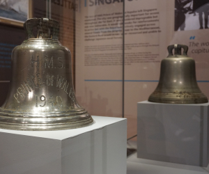 HMS Prince of Wales's ship bell in a display case. 