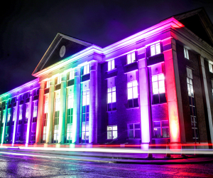 Royal Navy building lit up with rainbow lights. 