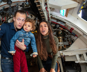 A family having fun onboard HMS Alliance. 