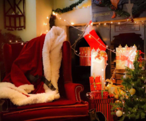 A festive fireplace decorated with lights and stockings