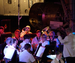 Band playing Christmas songs underneath Concorde