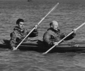 Archive photograph of Hasler and Stewart paddling a canoe at sea
