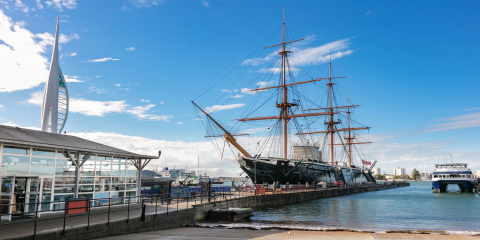 HMS Warrior floats next to Portsmouth Historic Dockyard's Visitor Centre.  