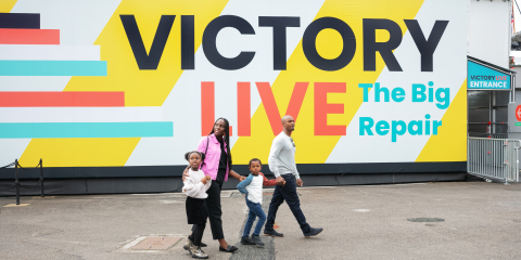 A family walk past Victory Live on their way to learn about her restoration. 
