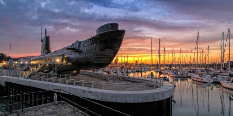 HMS Alliance sits in dock at Gosport harbour at sunset.